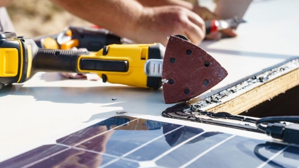 Technician performing RV roof leak repair on-site at Denver-area campground