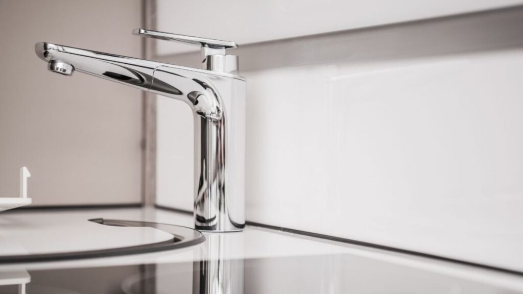 Close-up of RV fresh water and waste lines during an on-site diagnostic plumbing inspection